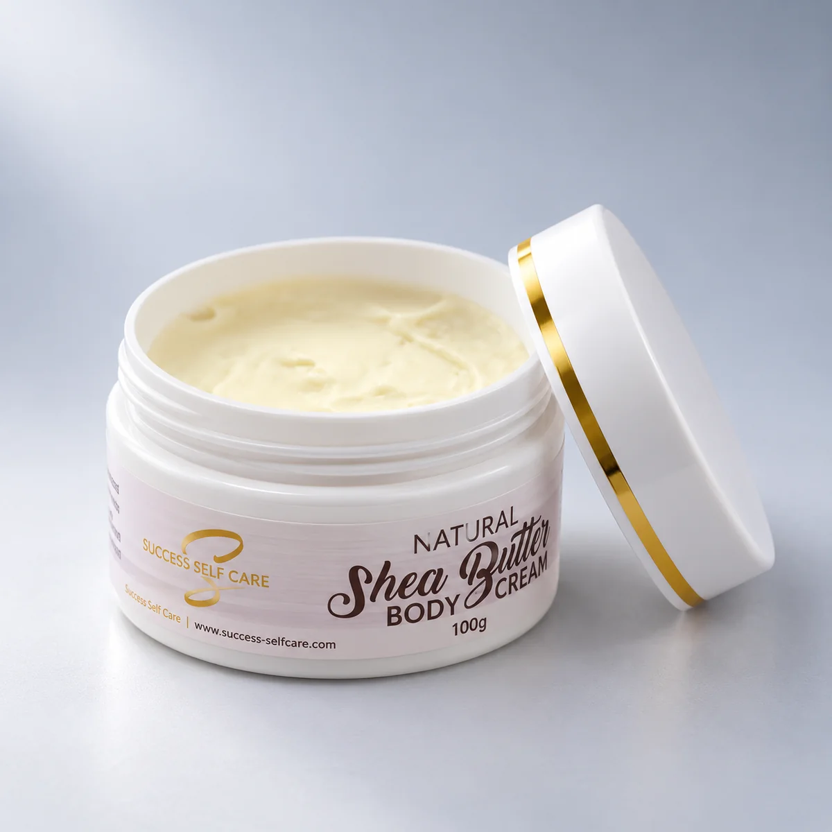 Open 100g jar of Success Self Care Whipped Shea Butter Body Cream showing the soft cream